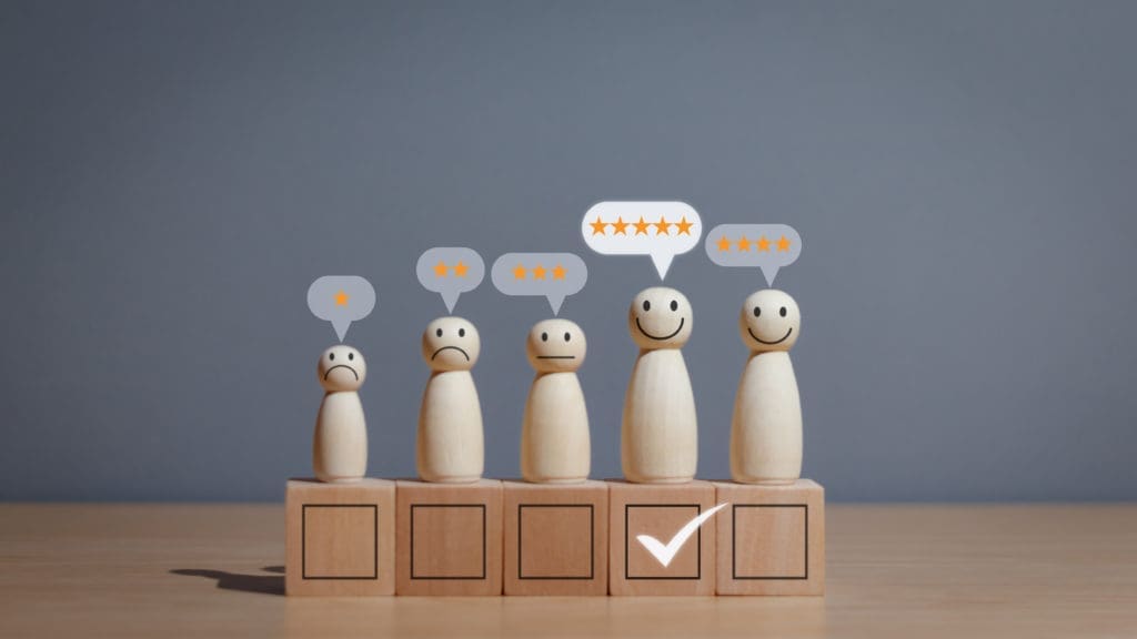 A group of wooden figures with a check mark on their heads.