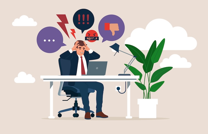 Illustration of a stressed man sitting at a desk, laptop open, surrounded by speech bubbles showing exclamations, a frown, and a thumbs down—visual cues of his struggle with online reputation defense. A potted plant and a lamp adorn the desk, set against a backdrop of clouds.