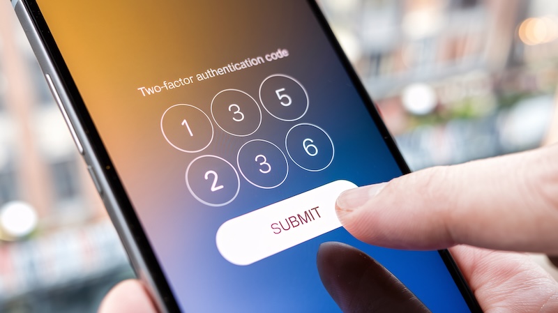 Close-up of a smartphone screen showing a two-factor authentication code interface with a number pad. A finger hovers over the red-highlighted "Submit" button, illustrating how to protect your privacy online, against a blurred background.