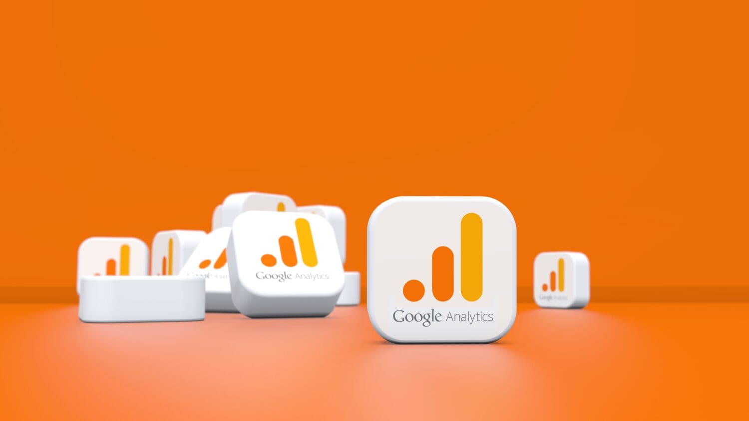 Cubes with the Google Analytics logo are scattered on an orange background.