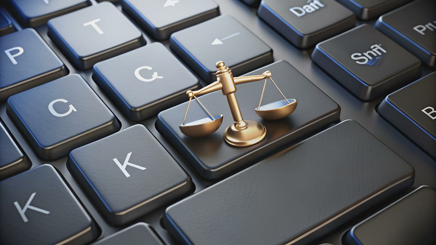 A small bronze scale of justice placed on a computer keyboard, symbolizing the intersection of law and technology. The scale sits atop the enter key, surrounded by other keys with letters and symbols, highlighting the digital context.