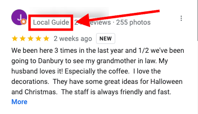 A Google review from a Local Guide with a five-star rating. The reviewer mentions visiting three times in the past year and appreciates the coffee, decorations, and friendly staff, highlighting ideas for Halloween and Christmas.