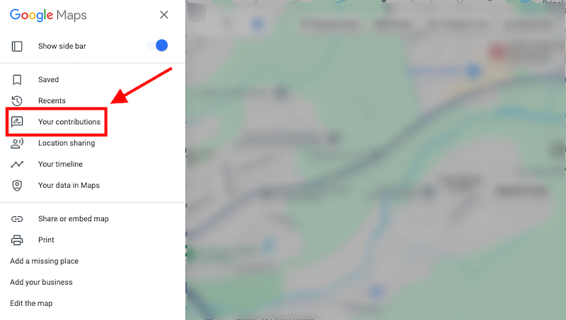 A screenshot of Google Maps with a red arrow pointing to the "Your contributions" tab in the side menu. The background shows a blurred map view.