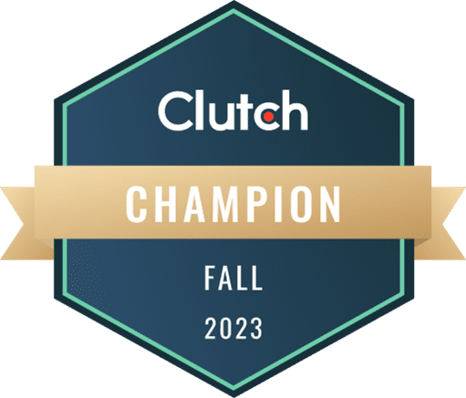 Hexagonal badge with a dark blue background and a light green outline. The text reads: "Clutch Champion Fall 2023" in white and gold. A beige ribbon crosses the badge horizontally with the word "Champion" displayed prominently.