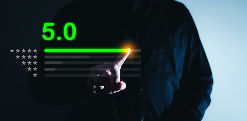 A person in a dark suit selecting a 5.0 rating on a futuristic digital screen with glowing green stars, representing top satisfaction or performance level for online reputation management companies.