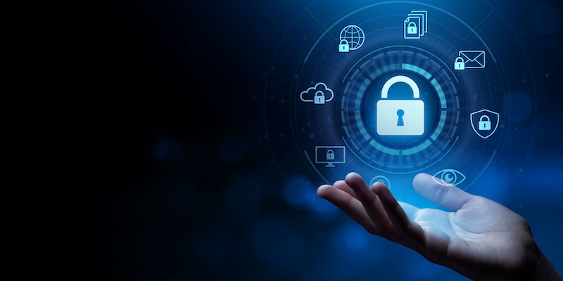 An open hand is shown against a dark, blurred background. Floating above the hand is a stylized digital lock icon surrounded by various connected symbols such as a cloud, globe, email, and documents, indicating security and data protection concepts.