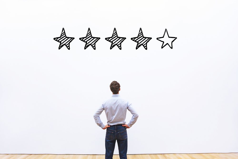 reputation management - man looking at star reviews